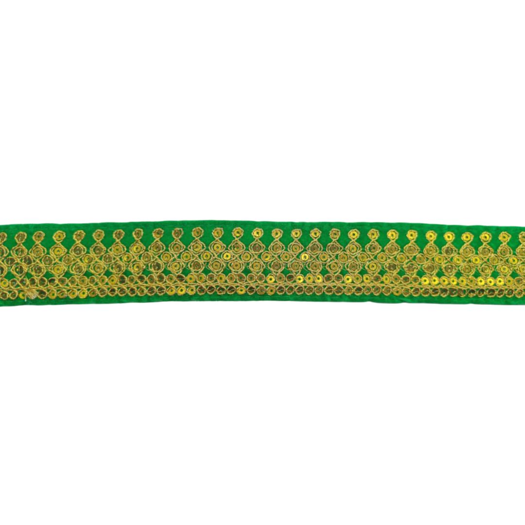 Green ribbon with gold sequin pattern on a white background